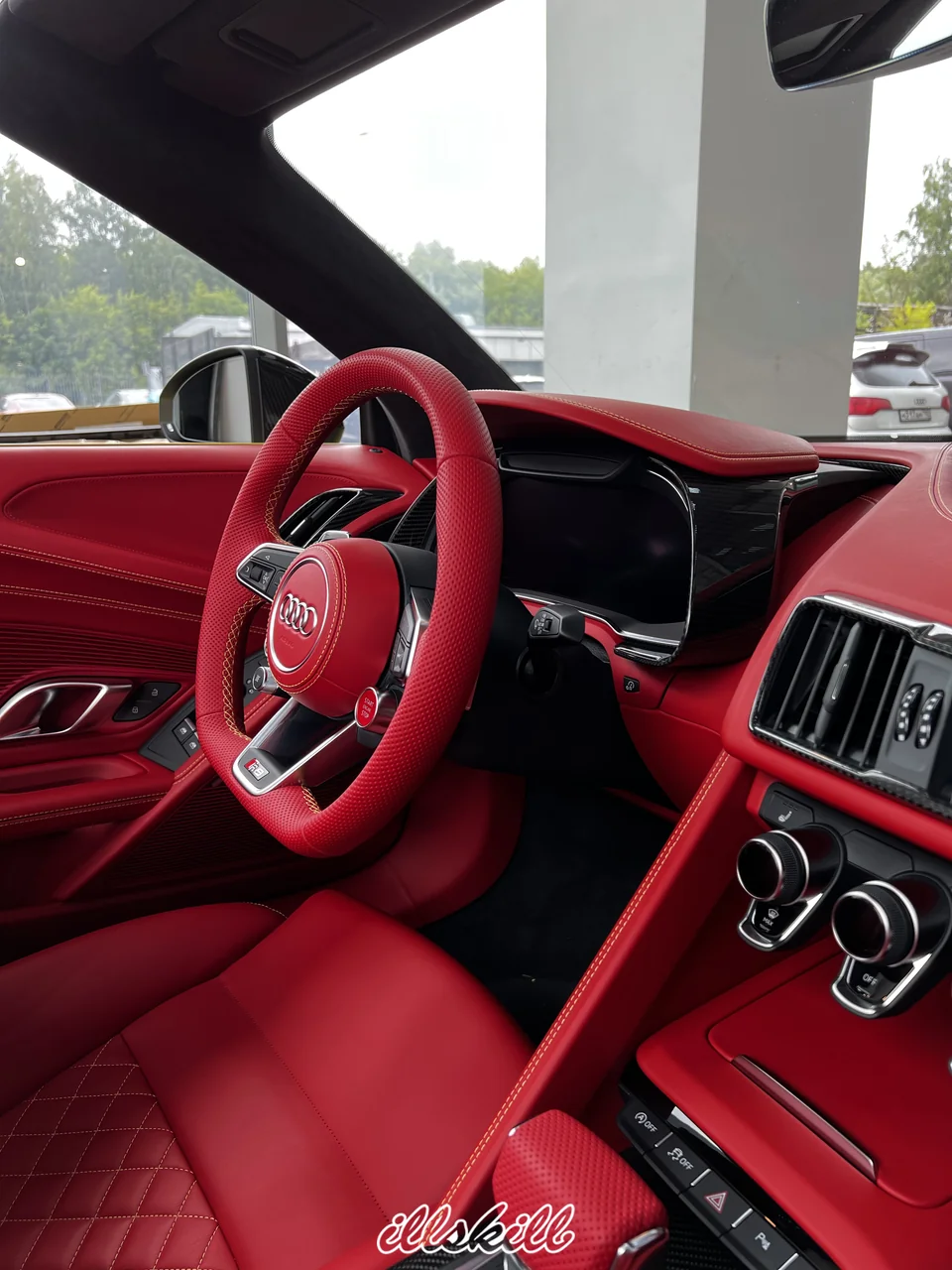 Красный перфорированный руль Audi в салоне с красной кожей и контрастной строчкой