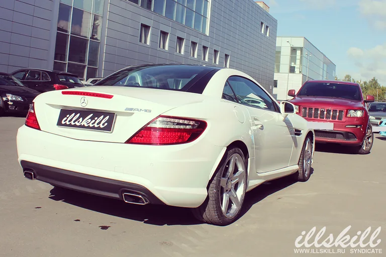 Задняя часть Mercedes-Benz SLK 200: фонари, тёмная вставка бампера и насадки выхлопа.