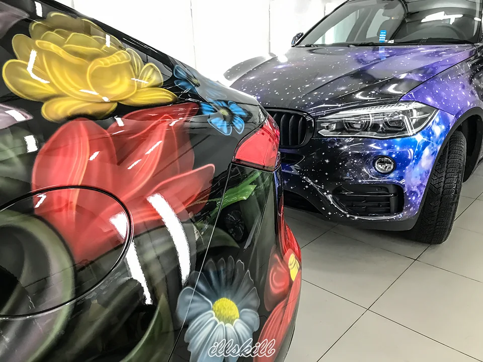 Цветочная и космическая роспись на кузовах двух автомобилей