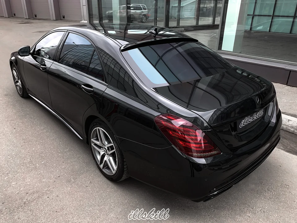 Чёрный седан Mercedes-Benz, вид сзади сбоку