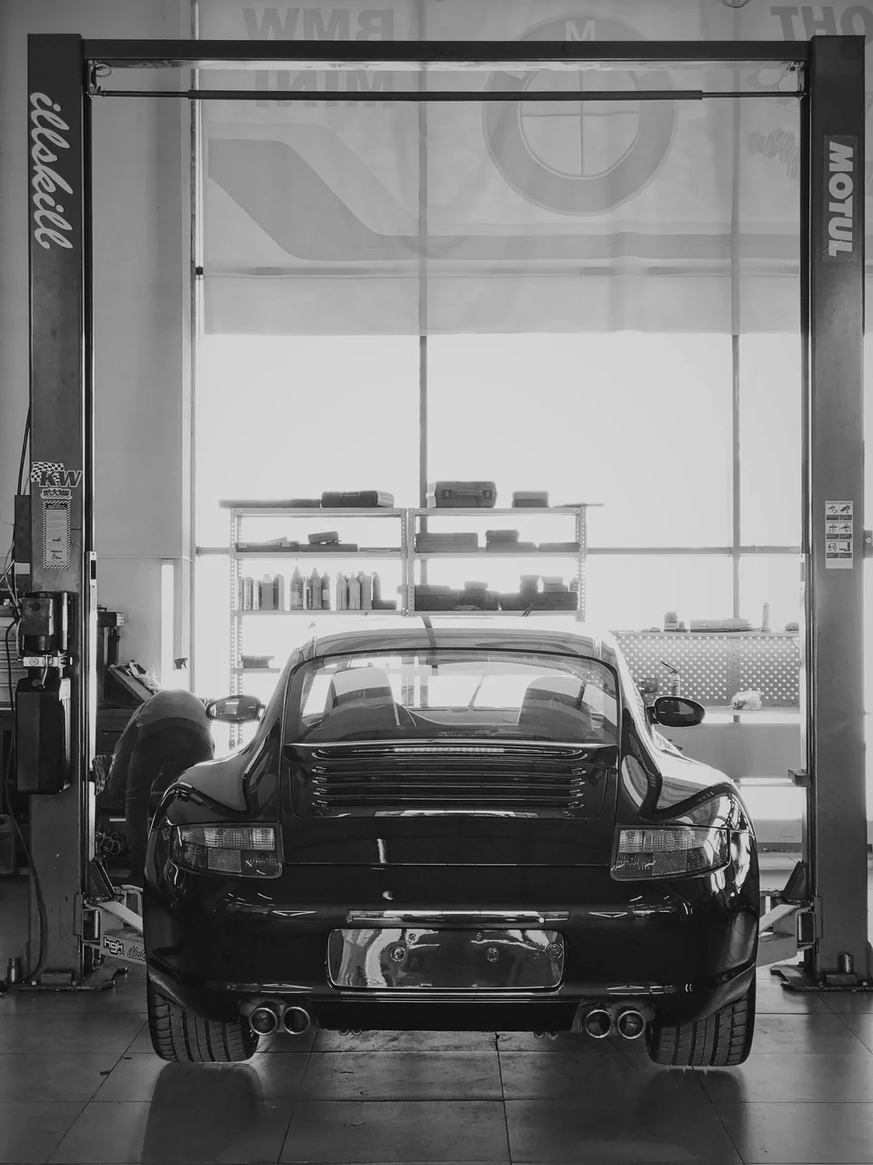 Porsche 911 на подъёмнике в мастерской ILLSKILL.